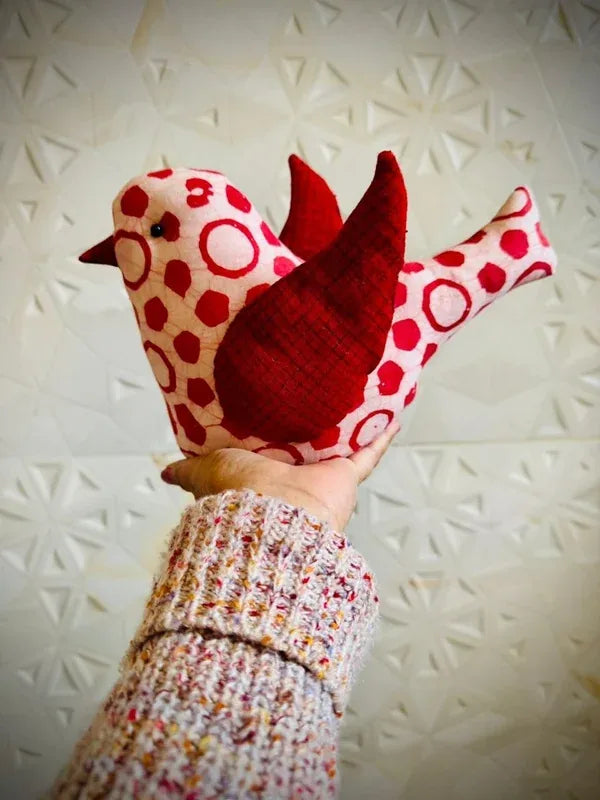 Close-up of a handmade fabric bird in red polka-dot print